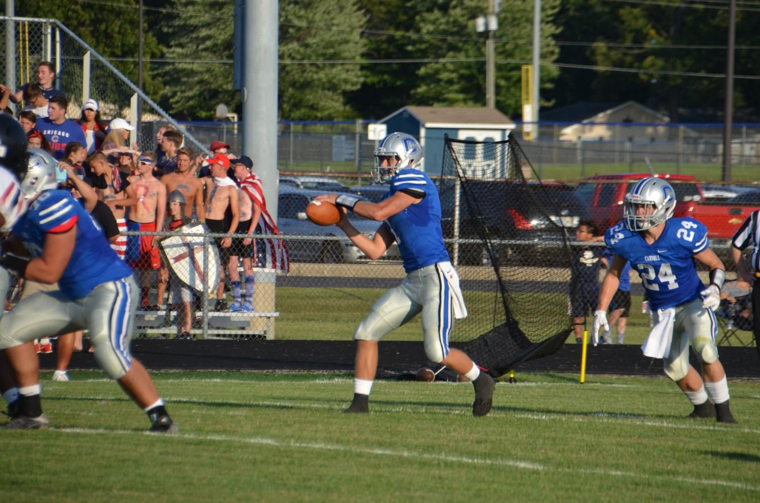 Seen here against Bishop Luers in the season opener, Jack Miguel takes the snap from center before a fake to running back Cam Shank. Photo by Hannah Harper