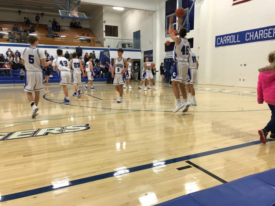 The JV Basketball team warms up at halftime during an January 2018 game. Junior Varsity playing time can give athletes the chance to get better and become strong enough to play varsity. Photo by Nol Beckley