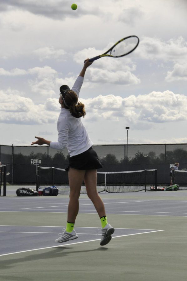 Mia Toscos serves last season. Along with her doubles partner, Lauren VanWyngarden, she hopes to get to the state finals again this year. File photo.