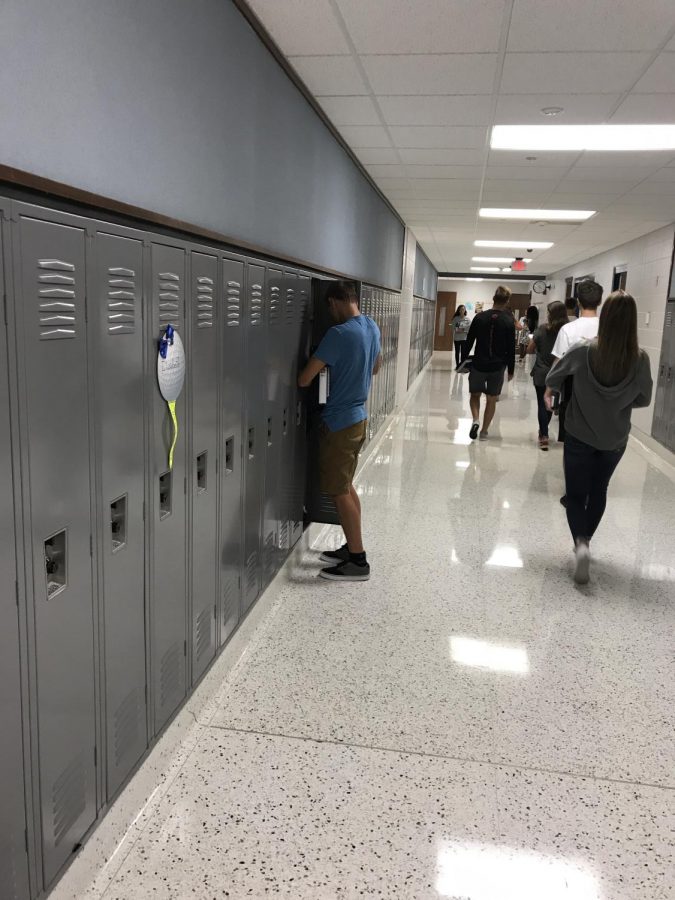 Sophomore Karsen Kast closes his second-floor locker on Monday, August 20 before his third period class. The high number of sophomores has caused the school to place 10th graders on the second floor. Photo by Nol Beckley. 