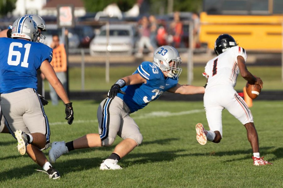 Larry Sible makes the tackle against the Bishop Luers running back during the season opener. The Chargers won 42-0.