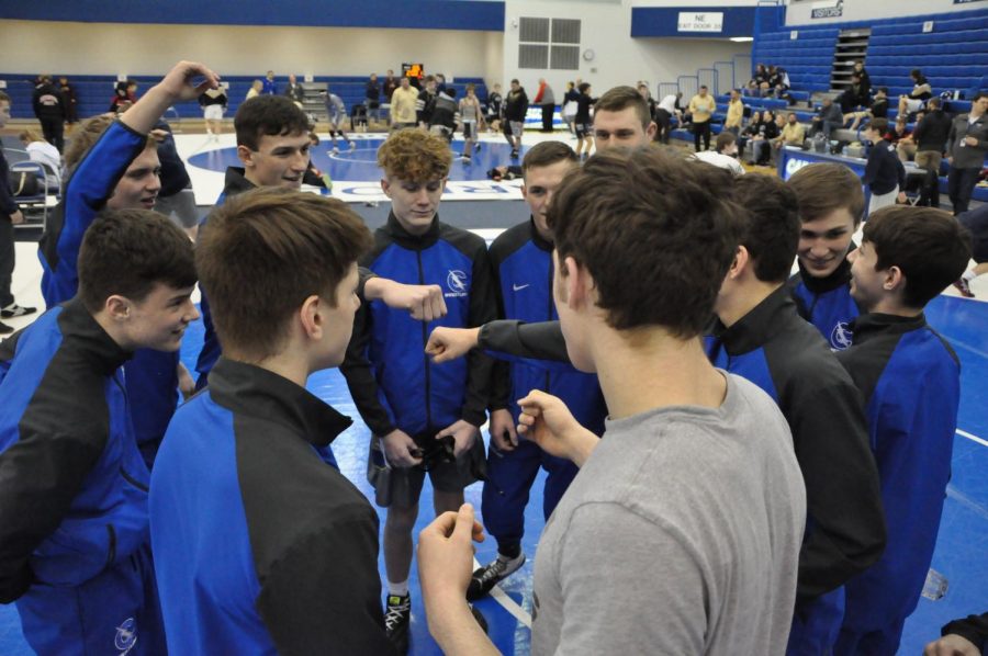 Before a series of dual meets in the fieldhouse, the team gets hyped up. 