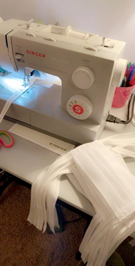 With her sewing machine, Junior Emily Linder made masks to help the care workers around the NACS community. 