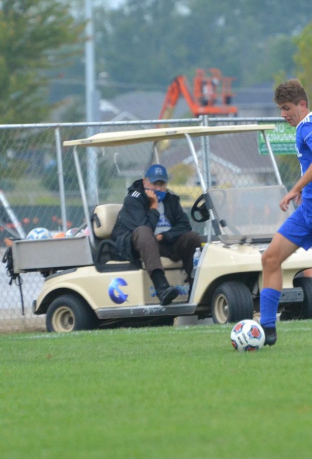 Coach Clements watches as his team takes possession of the ball.