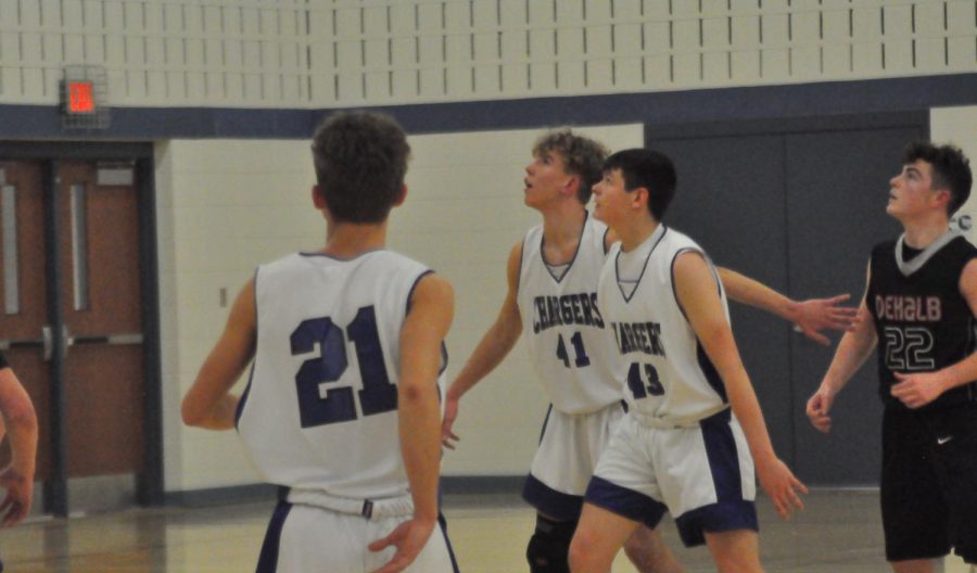 Freshmen Joey Taylor, Lane Outten, and Ty Burkey try to rebound the ball.