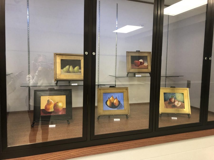 Display case in the school. Includes painting by Mattison Houser.