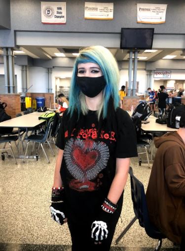 Tara Pishvaee, sophmore, wears a band t-shirt, skinny jeans, various bracelets, and skeleton gloves.