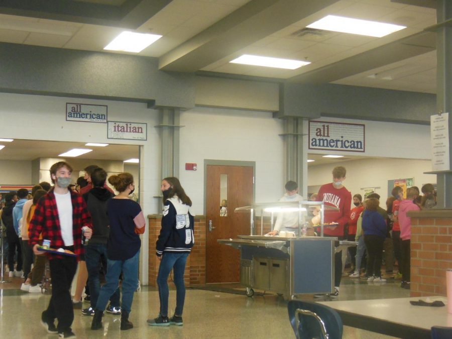 Students standing in line for lunch which has taken longer due to the shortages