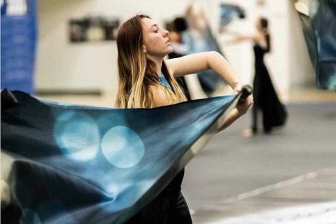 Junior Arwen Sparks performing in the JV color guard routine. Photo by Nancy Scholz.