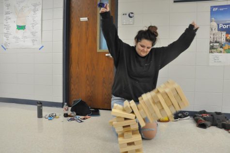 A freshman loses a game of Jenga at open gym night. Photo by Gwen McCleary.