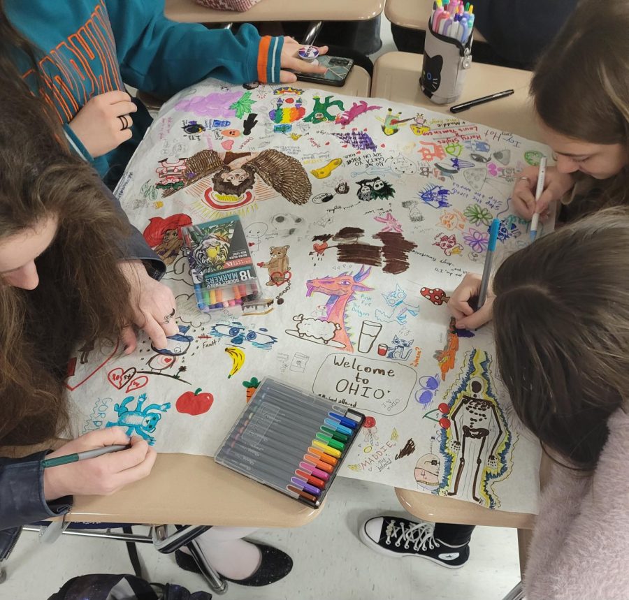 Students in the collaboritive art club working on their most recent piece.