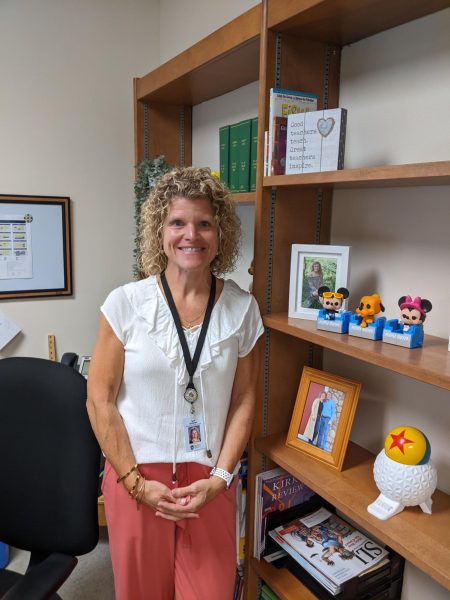 Teri Utchman poses in front of the new office