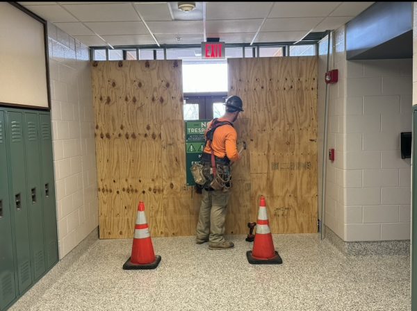 Construction workers block off door 6 on Friday, February 2, 2024, as part of the start of the $178 million rennovation and addition to the school. 