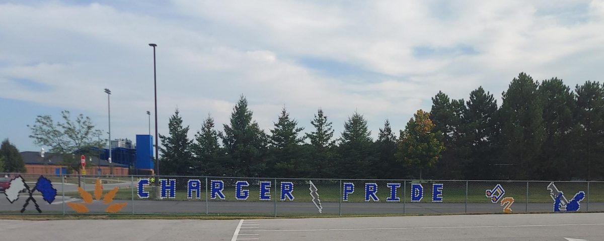 Sign on the fence of the marching band practice field 