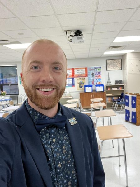 Dr. Taylor Buzzard wears a bowtie in his new classroom. Dr. Buzzard comes to the French Department from South Side High School. 