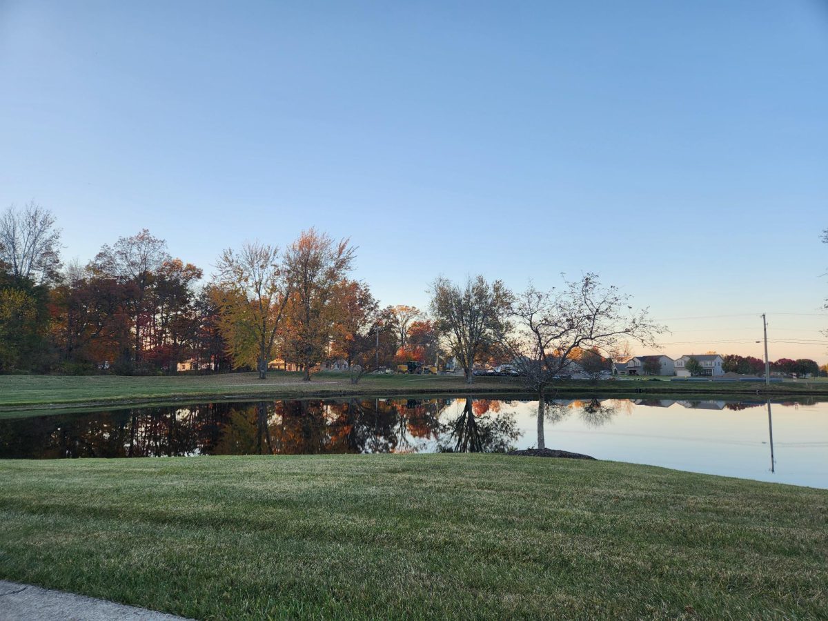 View people have from their houses facing Carroll Road. Beautiful sunset on pond with construction in background. Picture was taken sitting on a bench next to the pond for people to be able to watch the world go by and relax.