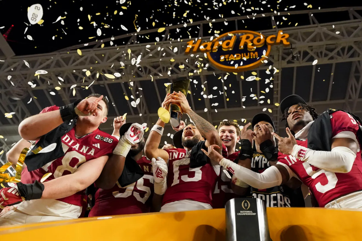 Indiana Hoosiers wide receiver Elijah Sarratt (13) raising the College Football Playoff National Championship Trophy Monday, Jan.19, 2026, after defeating the Miami (FL) Hurricanes at Hard Rock Stadium in Miami Gardens.