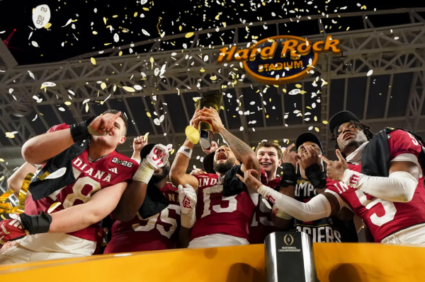 Indiana Hoosiers wide receiver Elijah Sarratt (13) raising the College Football Playoff National Championship Trophy Monday, Jan.19, 2026, after defeating the Miami (FL) Hurricanes at Hard Rock Stadium in Miami Gardens.